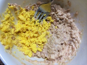 Yolk mashed into side of bowl before mixing in 